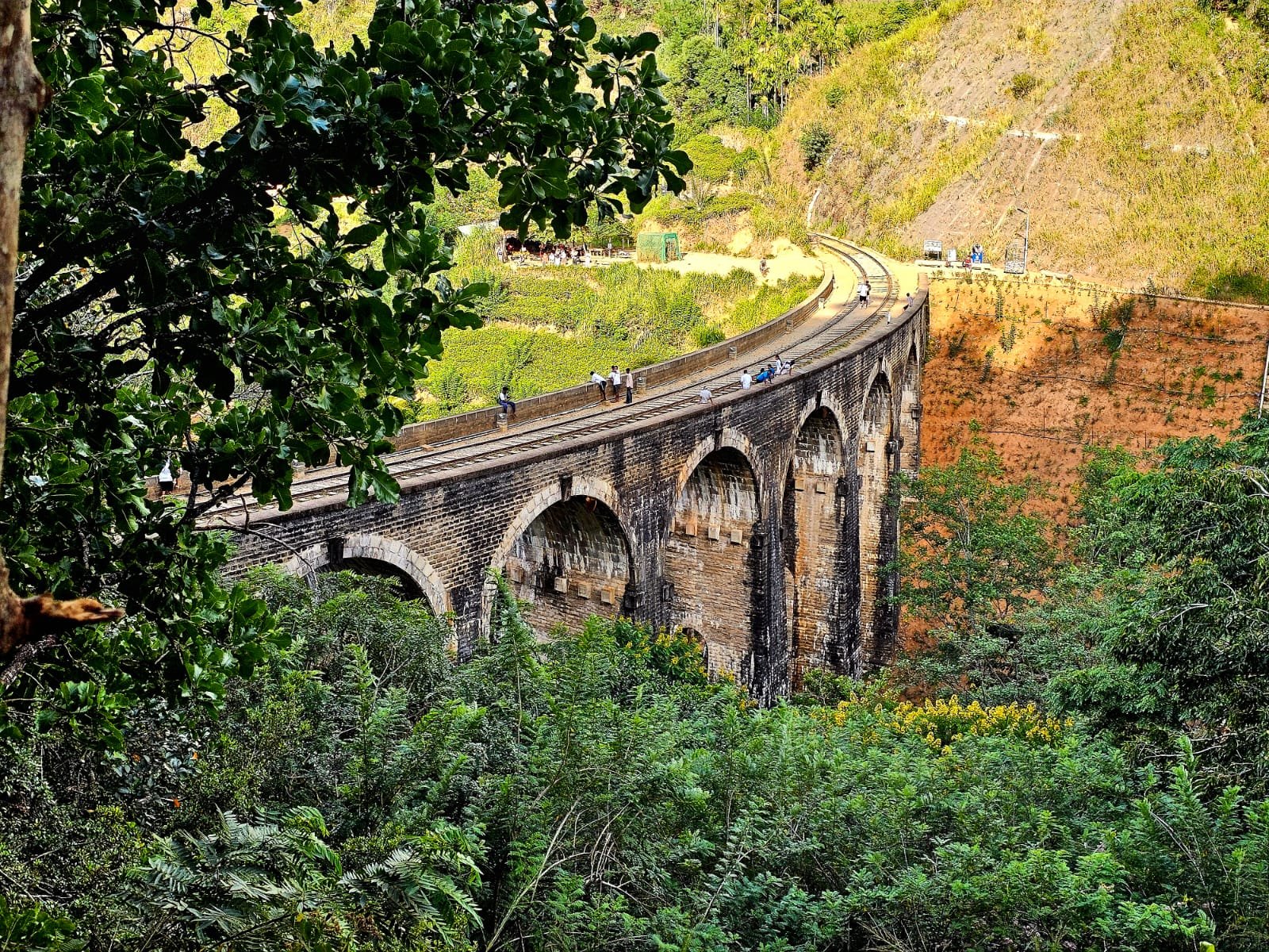 Nine Arch Bridge framed by lush hills